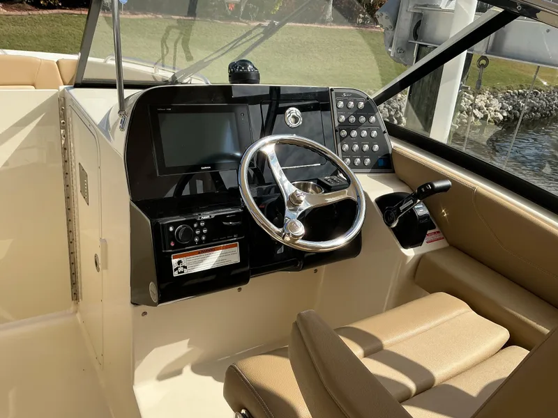 Slide: The Image of 2019 Scout 255 Dorado boat interior with tan seating and windshield. - 8