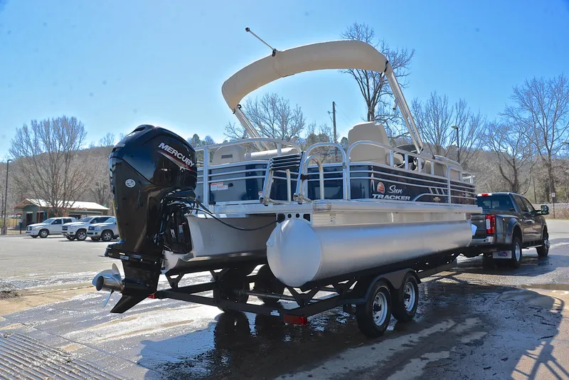 Slide: The Image of 2023 Sun Tracker Fishin Barge 20 DLX pontoon boat on trailer, ready for transport. - 14