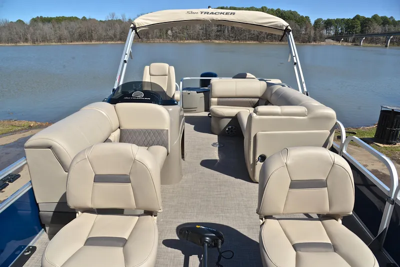 Slide: The Image of 2023 Sun Tracker Fishin Barge 20 DLX pontoon boat with spacious seating on a serene lake. - 20