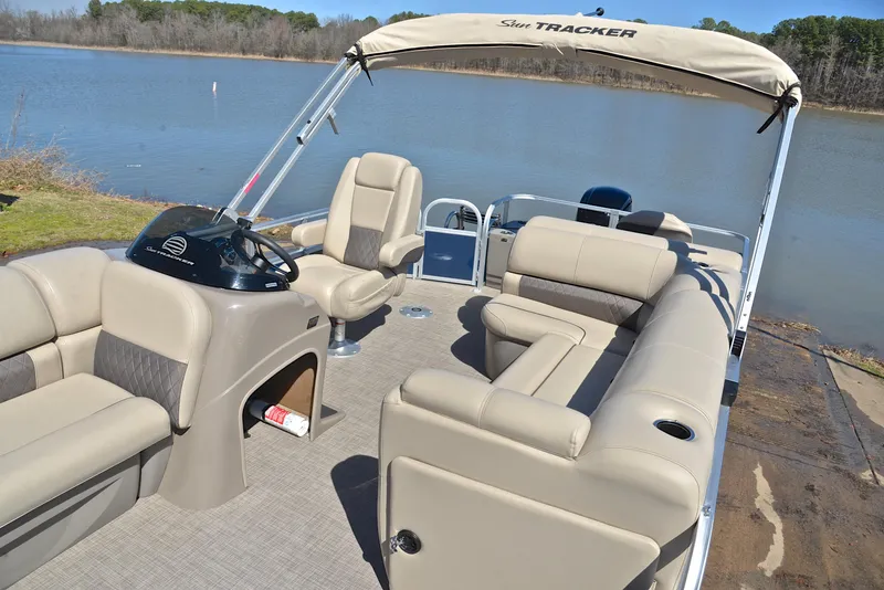 Slide: The Image of 2023 Sun Tracker Fishin Barge 20 DLX pontoon boat with spacious seating by a lake. - 21