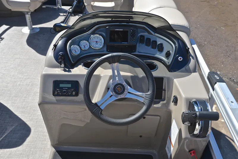Slide: The Image of 2023 Sun Tracker Fishin Barge 20 DLX dashboard with steering wheel and controls. - 26