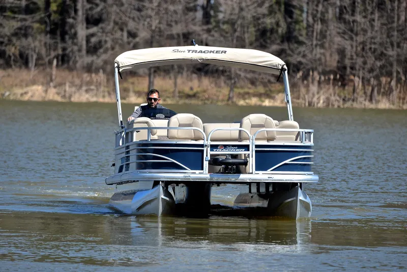 Slide: The Image of 2023 Sun Tracker Fishin Barge 20 DLX pontoon boat on a calm lake. - 9