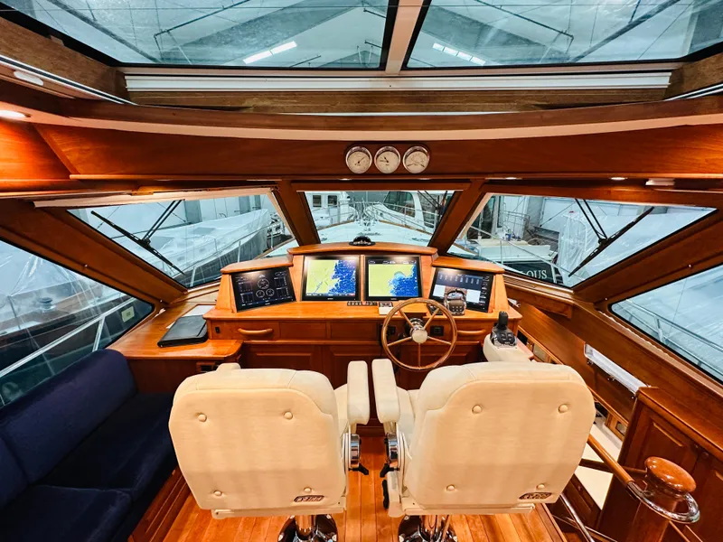 Slide: The Image of Interior of 2017 Sabre Salon Express yacht with dual helm seats and navigation screens. - 12