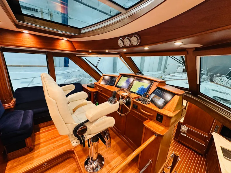 Slide: The Image of Luxurious 2017 Sabre Salon Express yacht interior with modern navigation equipment and plush seating. - 13