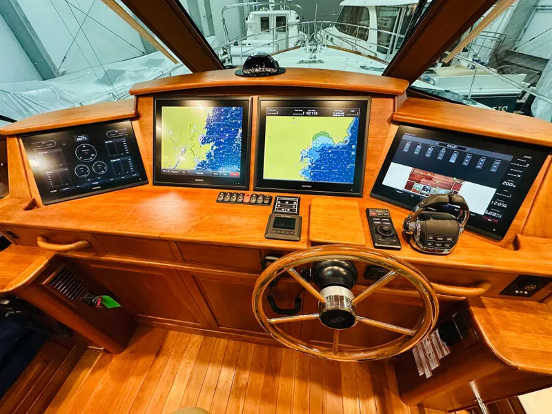 Slide: The Image of 2017 Sabre Salon Express helm with navigation screens and wooden steering wheel. - 15