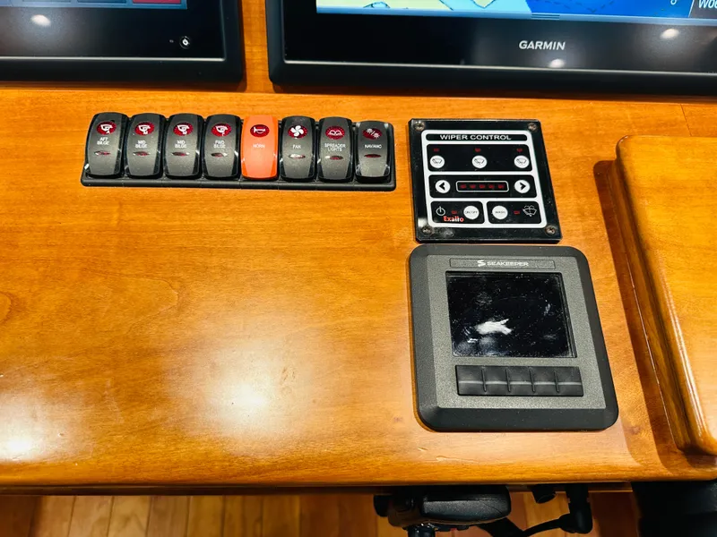 Slide: The Image of Control panel of a 2017 Sabre Salon Express boat with switches and wiper control. - 18