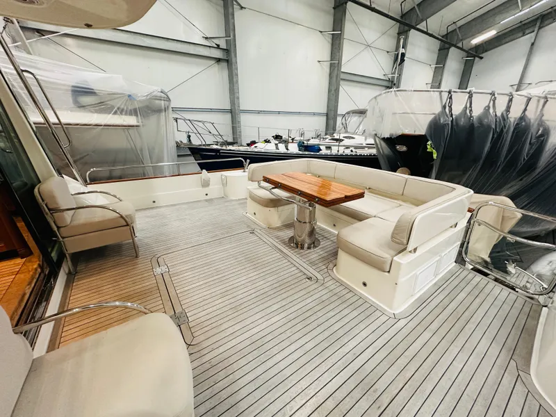 Slide: The Image of 2017 Sabre Salon Express yacht interior with seating and table in a storage facility. - 2