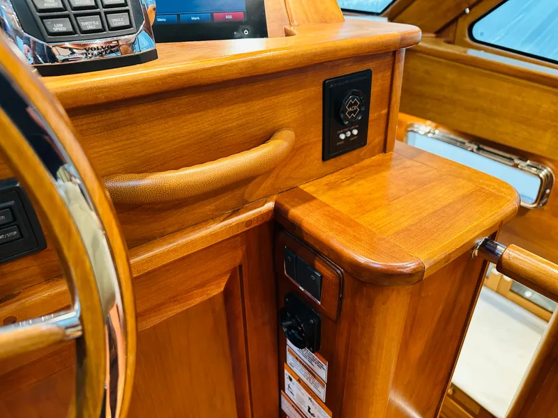 Slide: The Image of 2017 Sabre Salon Express helm with polished wood finish and control panel. - 21