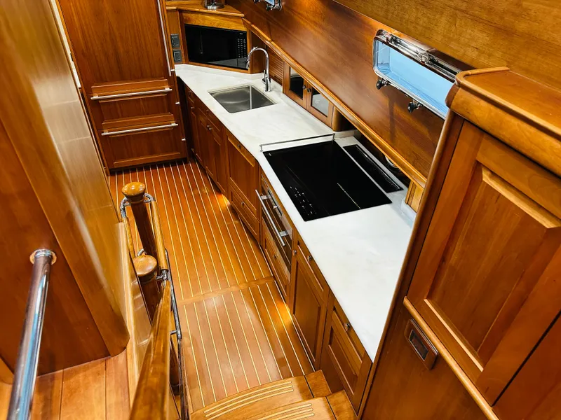 Slide: The Image of Luxurious 2017 Sabre Salon Express yacht interior with modern kitchen and wooden finishes. - 23