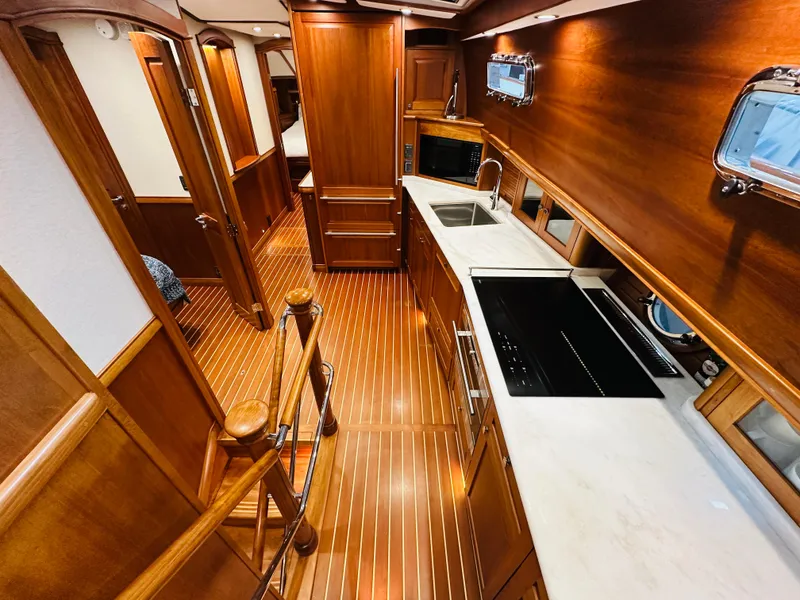 Slide: The Image of Luxurious 2017 Sabre Salon Express yacht interior with wooden finishes and modern kitchen amenities. - 24