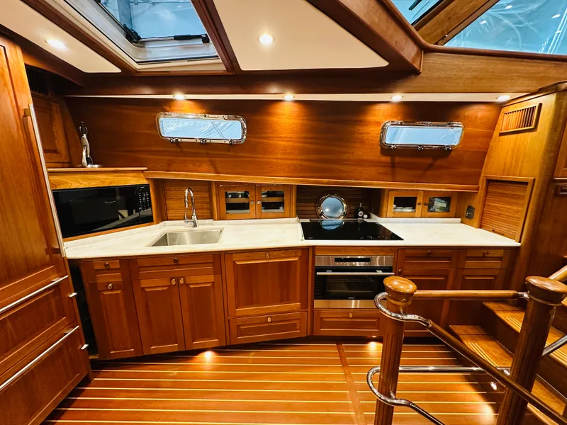 Slide: The Image of Luxurious 2017 Sabre Salon Express yacht interior with elegant wooden cabinetry and modern kitchen amenities. - 25