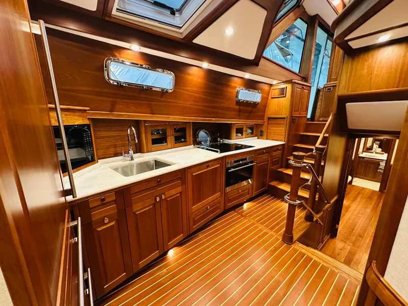 Slide: The Image of Luxurious 2017 Sabre Salon Express yacht interior with elegant wooden cabinetry and modern kitchen amenities. - 26