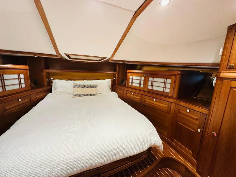 Slide: The Image of Luxurious 2017 Sabre Salon Express cabin with elegant wood finish and cozy bedding. - 29