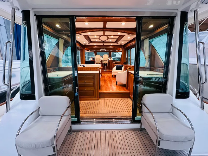 Slide: The Image of 2017 Sabre Salon Express yacht interior with elegant wood finish and plush seating. - 3