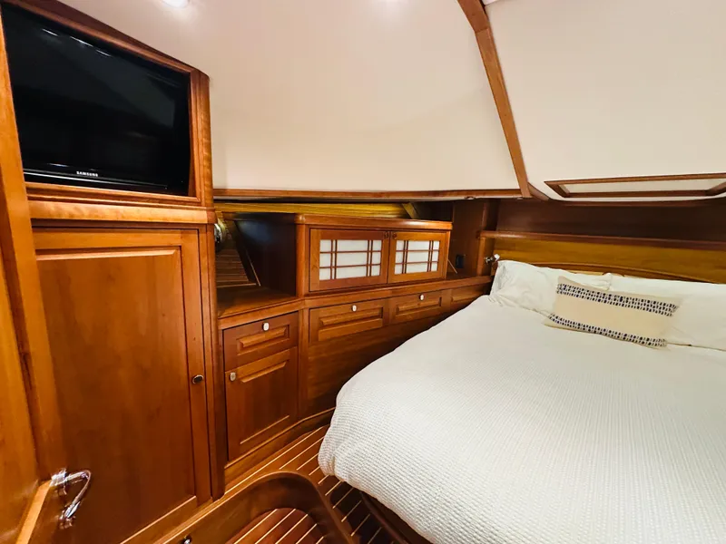 Slide: The Image of Luxurious 2017 Sabre Salon Express cabin with wood finish and cozy bedding. - 30