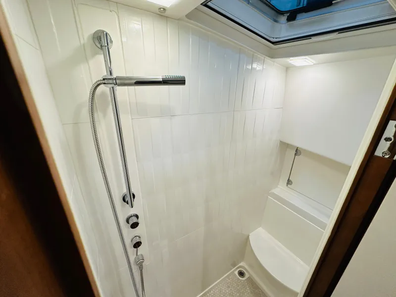 Slide: The Image of Modern shower area in 2017 Sabre Salon Express yacht, featuring sleek fixtures and white tiles. - 31