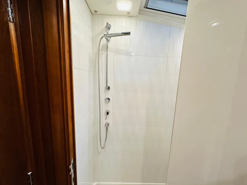 Slide: The Image of Shower area in 2017 Sabre Salon Express yacht with modern fixtures and white tiles. - 32