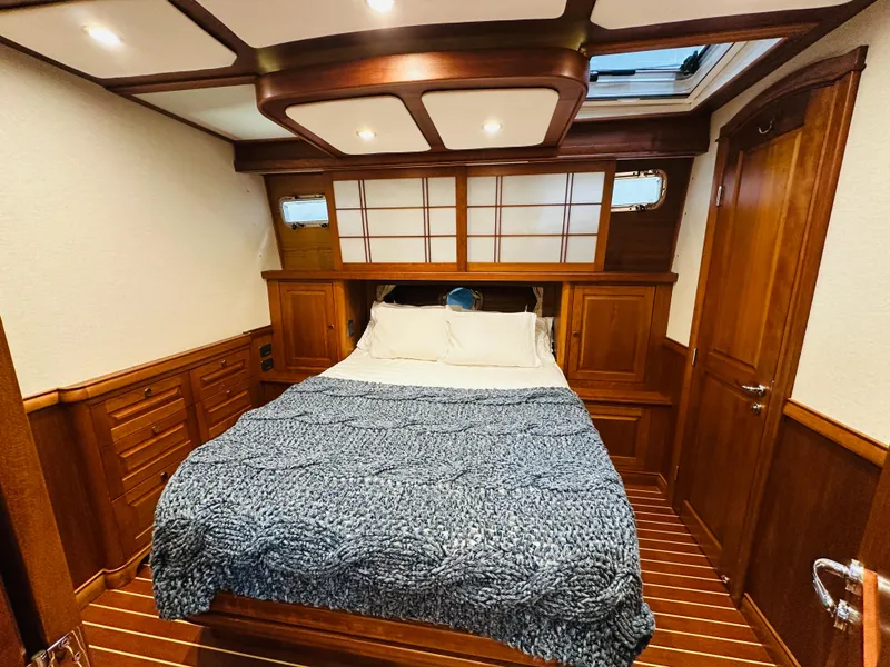Slide: The Image of Luxurious 2017 Sabre Salon Express bedroom with wood paneling and cozy bedding. - 34