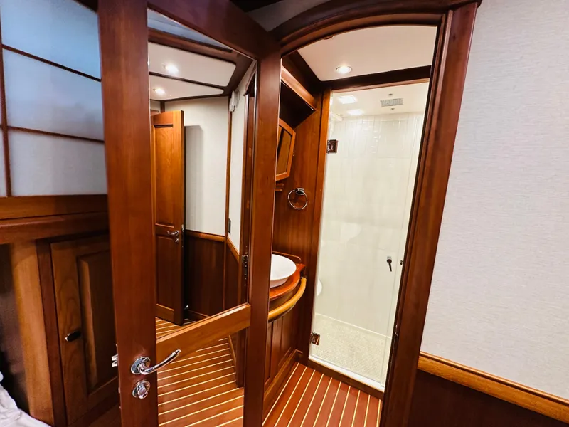 Slide: The Image of 2017 Sabre Salon Express interior with wooden finish and modern bathroom. - 36
