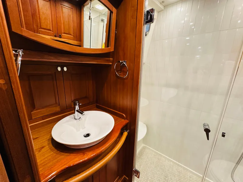 Slide: The Image of Luxurious bathroom in 2017 Sabre Salon Express yacht with wooden cabinetry and modern fixtures. - 37