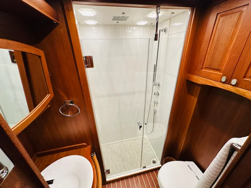 Slide: The Image of 2017 Sabre Salon Express bathroom with wooden cabinetry and glass shower enclosure. - 39