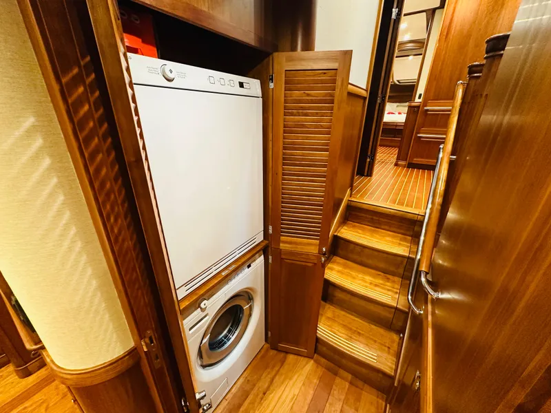 Slide: The Image of 2017 Sabre Salon Express interior with washer-dryer, wooden stairs, and cabinetry. - 41