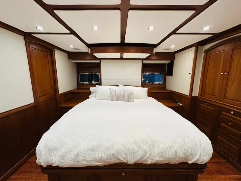 Slide: The Image of Luxurious bedroom interior of 2017 Sabre Salon Express yacht with wood paneling and cozy bedding. - 45