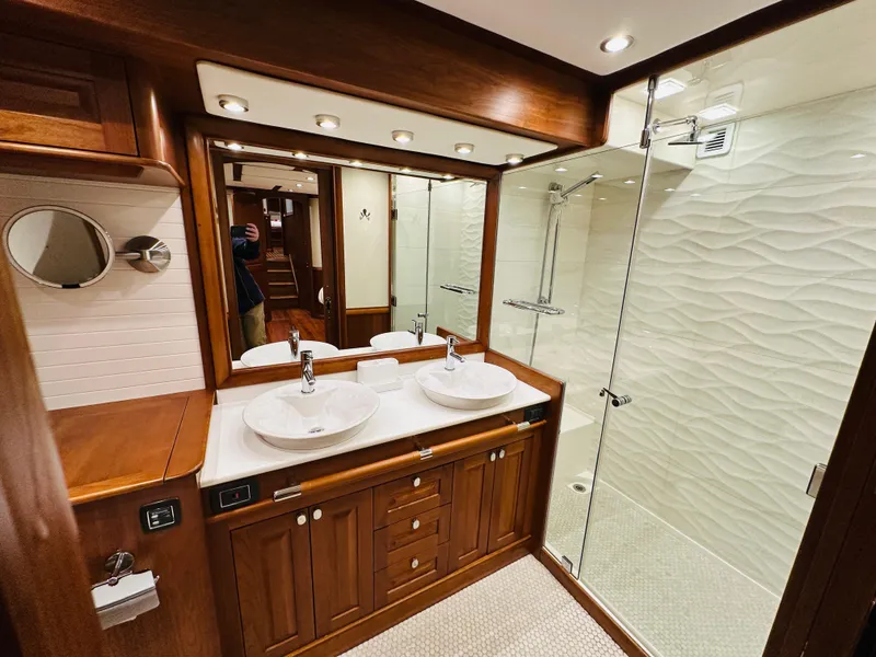 Slide: The Image of Luxurious bathroom in 2017 Sabre Salon Express yacht with dual sinks and glass shower. - 46