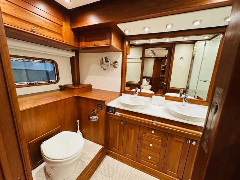 Slide: The Image of Luxurious wooden bathroom interior in 2017 Sabre Salon Express yacht, featuring dual sinks and elegant design. - 47