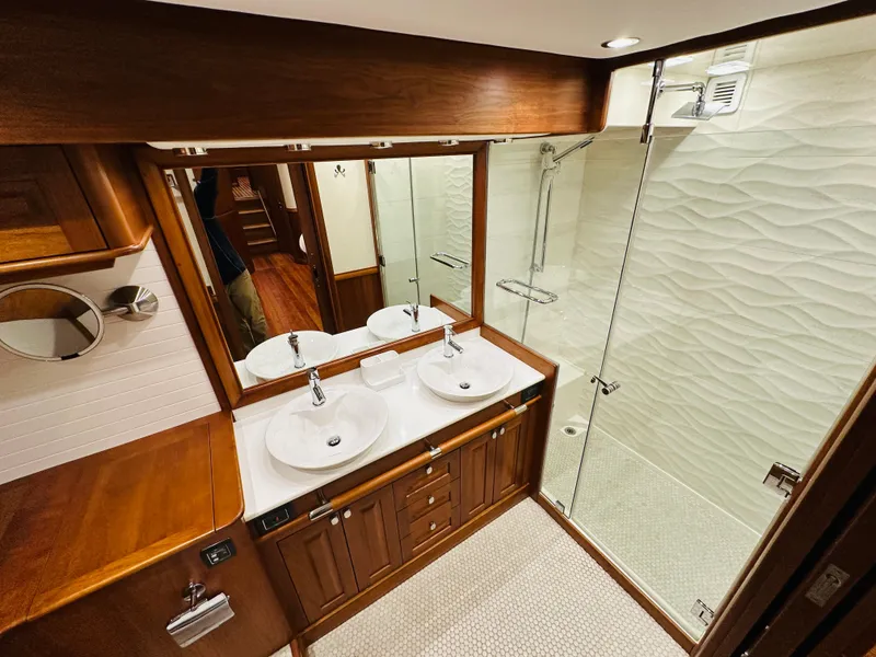 Slide: The Image of Luxurious bathroom in 2017 Sabre Salon Express yacht with dual sinks and glass shower. - 48