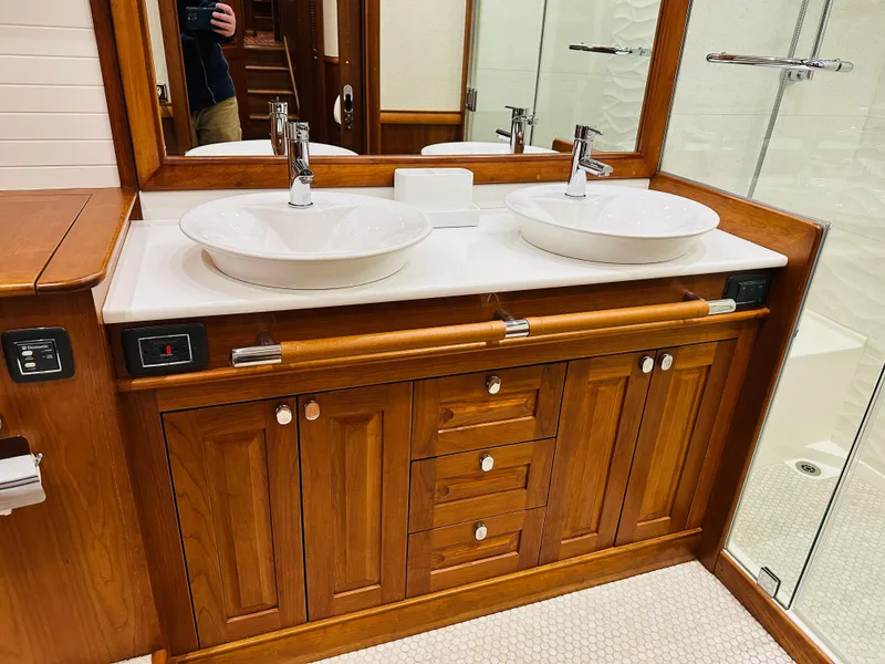 Slide: The Image of Luxurious wooden bathroom vanity with dual sinks in 2017 Sabre Salon Express yacht. - 49