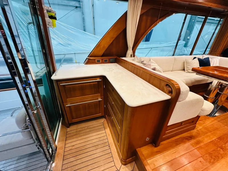 Slide: The Image of 2017 Sabre Salon Express interior with wooden cabinetry and seating area. - 8