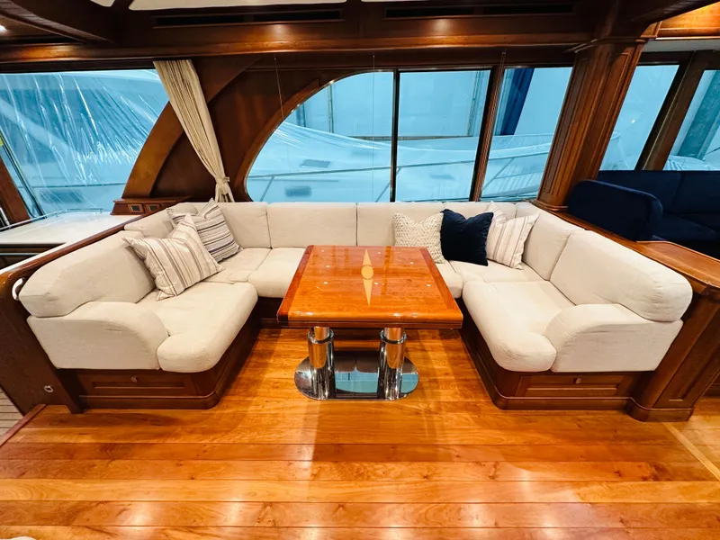 Slide: The Image of Luxurious 2017 Sabre Salon Express yacht interior with elegant seating and wooden table. - 9