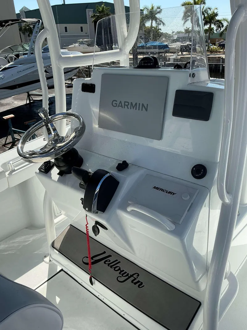Slide: The Image of 2023 Yellowfin 26 CC Hybrid boat console with Garmin display and Mercury controls. - 10