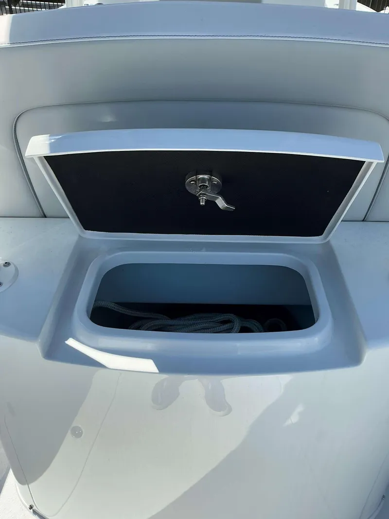 Slide: The Image of 2023 Yellowfin 26 CC Hybrid boat storage compartment with open lid. - 12