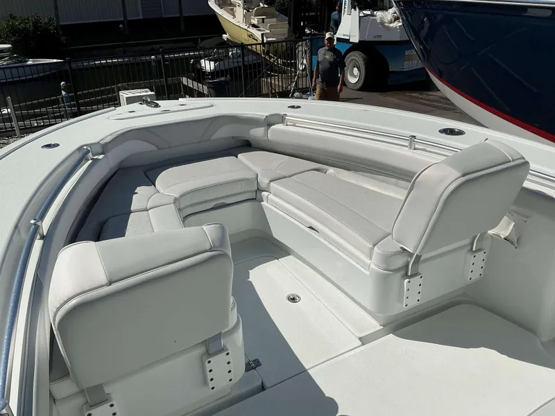 Slide: The Image of 2023 Yellowfin 26 CC Hybrid boat interior with cushioned seating. - 13