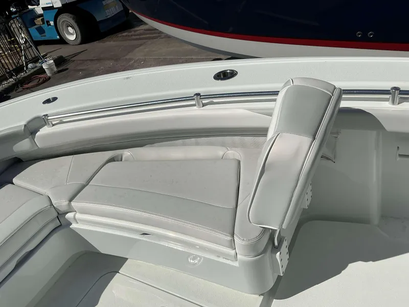 Slide: The Image of 2023 Yellowfin 26 CC Hybrid boat interior with cushioned seating. - 14