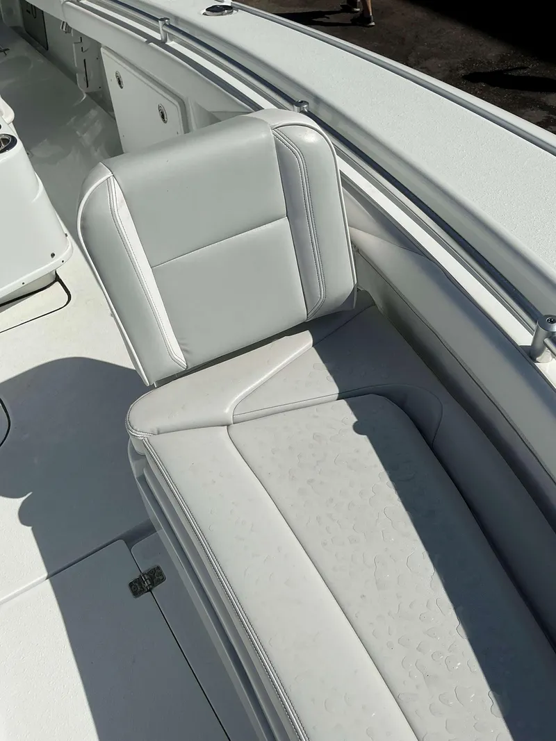Slide: The Image of 2023 Yellowfin 26 CC Hybrid boat interior with white cushioned seating. - 15