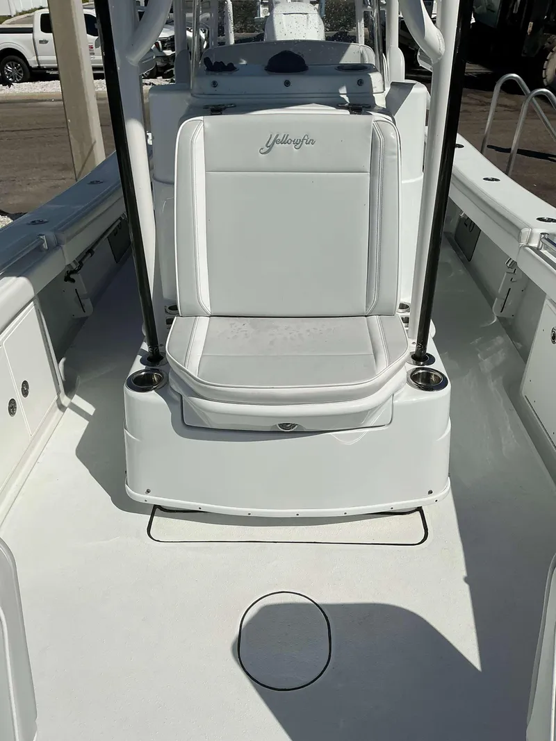 Slide: The Image of 2023 Yellowfin 26 CC Hybrid boat interior with seating and console. - 16