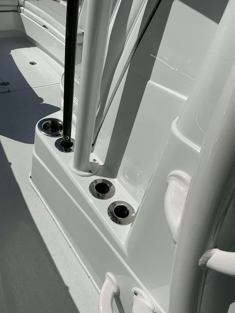 Slide: The Image of 2023 Yellowfin 26 CC Hybrid boat interior with rod holders and seating. - 5