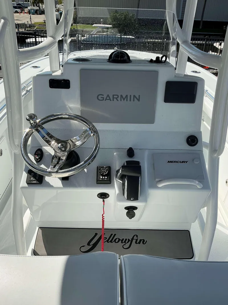 Slide: The Image of 2023 Yellowfin 26 CC Hybrid boat console with Garmin and Mercury controls. - 9