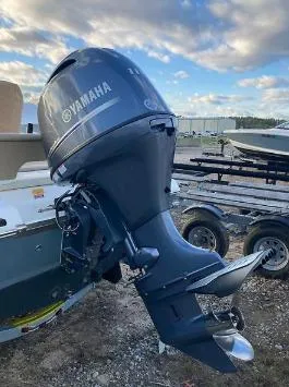 Slide: The Image of 2020 Key West 189 FS boat with Yamaha outboard motor, parked on a trailer. - 2