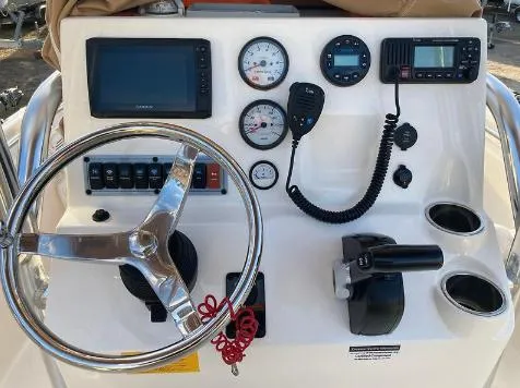 Slide: The Image of 2020 Key West 189 FS boat dashboard with steering wheel, gauges, and controls. - 3