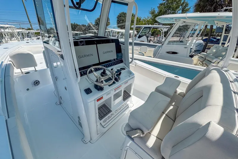 Slide: The Image of 2025 Sea Hunt Gamefish 28 FS boat interior with Garmin displays and comfortable seating. - 6