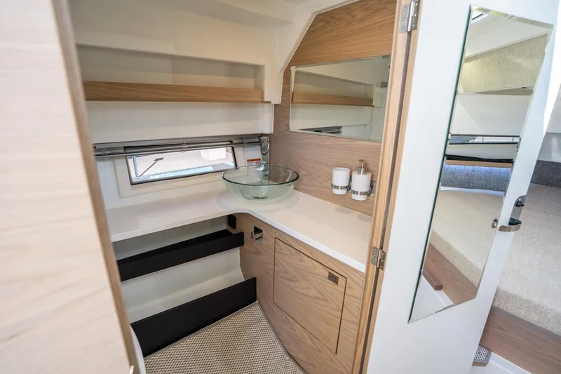 Slide: The Image of Interior of 2025 Quarken 35 Sport Tourer, featuring modern bathroom with glass sink and wood accents. - 39
