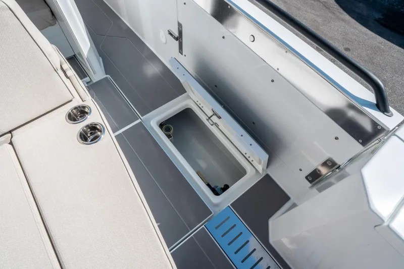 Slide: The Image of 2025 Quarken 35 Sport Tourer interior storage compartment with sleek design and cup holders. - 18