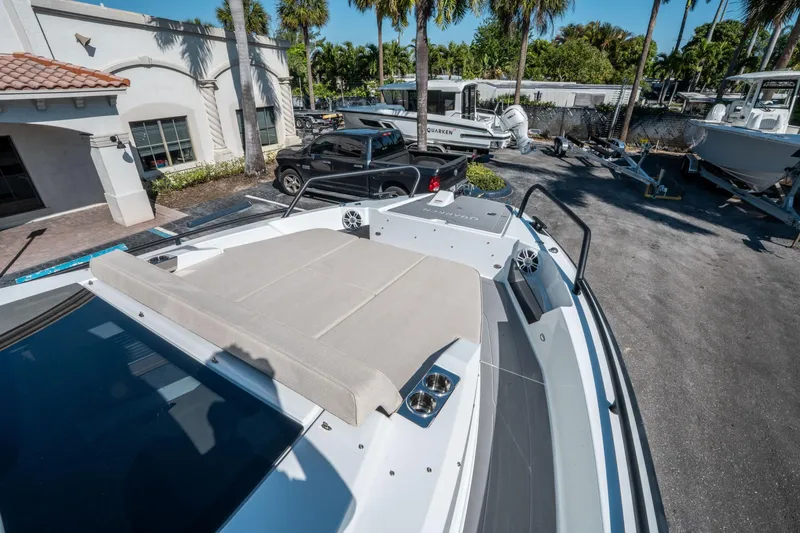 Slide: The Image of 2025 Quarken 35 Sport Tourer boat with sunbed, parked near palm trees. - 29