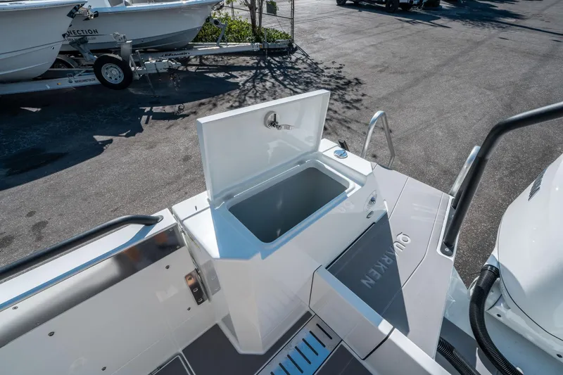 Slide: The Image of 2025 Quarken 35 Sport Tourer boat deck with open storage compartment. - 13
