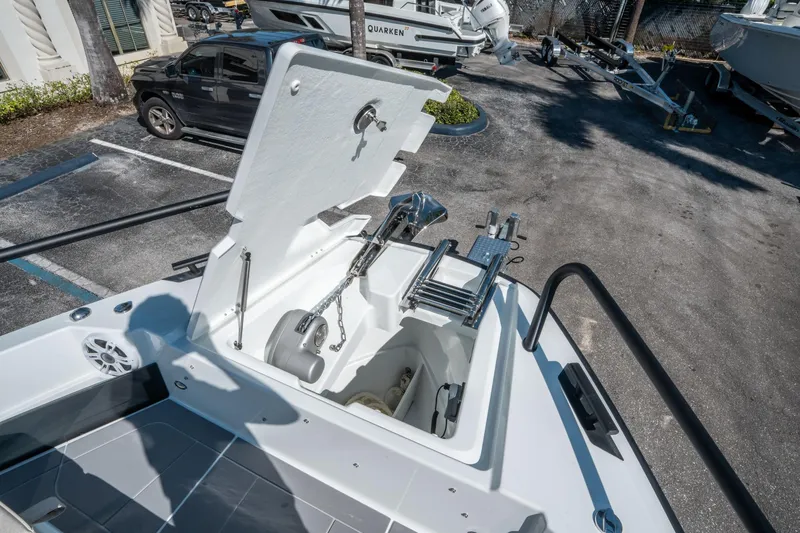 Slide: The Image of 2025 Quarken 35 Sport Tourer boat anchor compartment with ladder in a parking lot. - 32