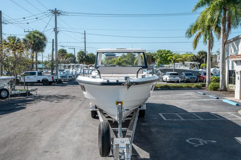 Slide: The Image of 2025 Quarken 35 Sport Tourer boat on trailer in sunny parking lot. - 7